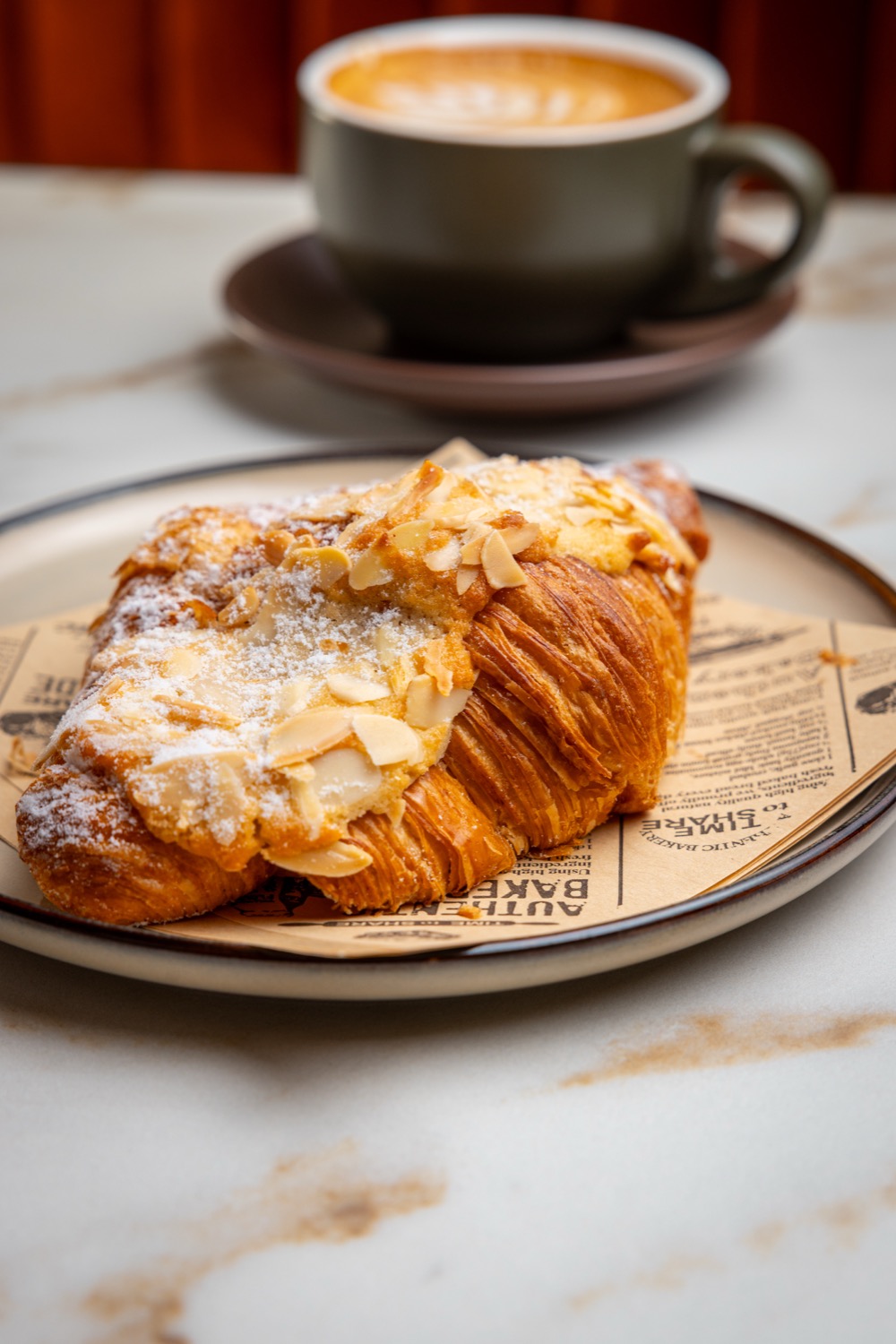 An almond croissant and a flat white at The Oak & Bean